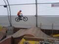 Mountain biker transferring across to the large Step-Up jump...