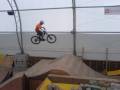 Biker getting big air, transferring over the gap to the step-up tabletop