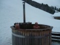 The homemade barrel-construction hottub - note the submerged stove with chimney
